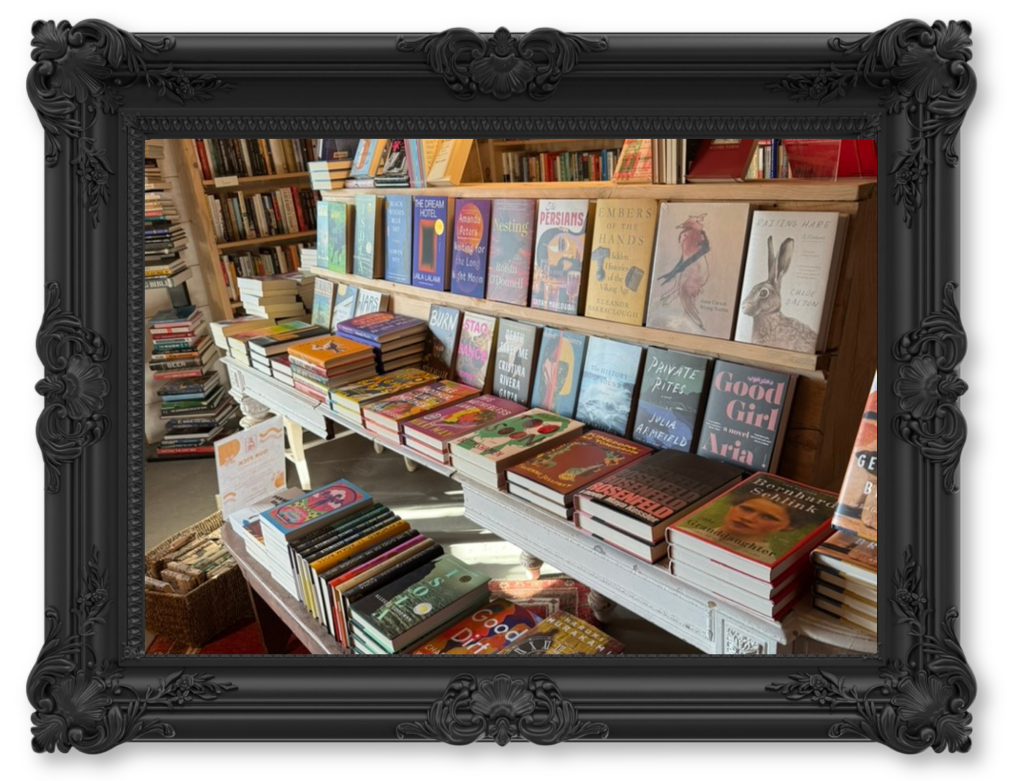 Bookshelf with books inside a black decorative frame